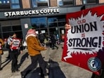 Workers picket in front of a Starbucks in the Brooklyn borough in New York, U.S. December 23, 2024. REUTERS/Eduardo Munoz