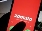 The logo of Indian food delivery company Zomato is seen on its app on a mobile phone displayed in front of its company website in this illustration picture taken July 14, 2021