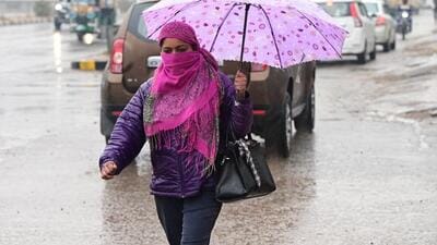 A woman makes her way through puddled roads in Chandigarh on Monday. (kESHAV SINGH/HT) A woman makes her way through puddled roads in Chandigarh on Monday. (kESHAV SINGH/HT)