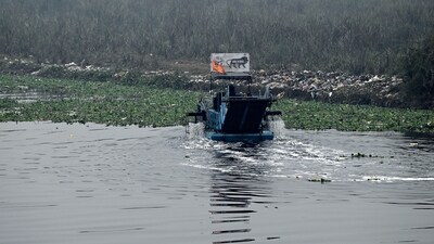 A trash skimmer machine works in the waters of the Yamuna River on a winter morning, in New Delhi on Monday. (Mohd Zakir ) A trash skimmer machine works in the waters of the Yamuna River on a winter morning, in New Delhi on Monday. (Mohd Zakir )