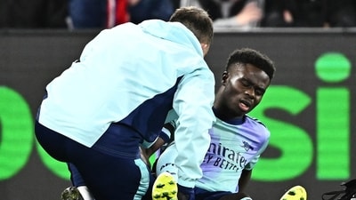 Arsenal's Bukayo Saka receives medical attention after sustaining an injury. (REUTERS)