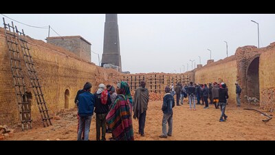 People gather after a wall collapsed at a kiln in Hisar district on Monday. (PTI)