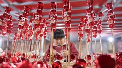 A worker makes Christmas decorations at a workshop in Huaibei, in China's eastern Anhui Province. (AFP) A worker makes Christmas decorations at a workshop in Huaibei, in China's eastern Anhui Province. (AFP)