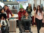American Airlines partner's worker providing wheelchair assistance, to a traveler at Miami International Airport, on Christmas Eve, Tuesday, Dec. 24, 2024, in Miami. (AP Photo/Rebecca Blackwell) American Airlines partner's worker providing wheelchair assistance, to a traveler at Miami International Airport, on Christmas Eve, Tuesday, Dec. 24, 2024, in Miami. (AP Photo/Rebecca Blackwell)