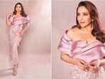 Madhuri Dixit dazzled in a lilac ensemble featuring an off-shoulder satin blouse and embellished bodycon skirt. Madhuri Dixit dazzled in a lilac ensemble featuring an off-shoulder satin blouse and embellished bodycon skirt.