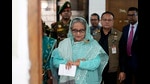 Bangladesh former Prime Minister Sheikh Hasina checks her watch as she waits for the official opening time to cast her vote in Dhaka, Bangladesh, Jan. 7, 2024. (AP Photo/Altaf Qadri) (AP)