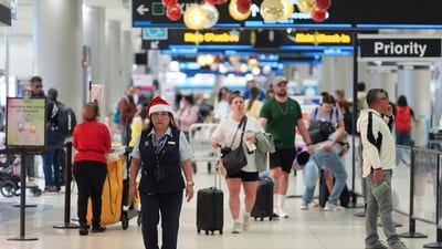 An American Airlines employee wearing a Santa Claus hat walks through the American terminal at Miami International Airport, on Christmas Eve, Tuesday, Dec. 24, 2024, in Miami. (AP Photo/Rebecca Blackwell) (AP) An American Airlines employee wearing a Santa Claus hat walks through the American terminal at Miami International Airport, on Christmas Eve, Tuesday, Dec. 24, 2024, in Miami. (AP Photo/Rebecca Blackwell) (AP)