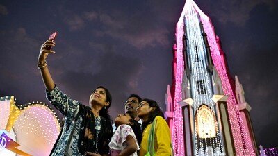 Families gathered to take pictures with the lit up St Mary's Basilica Church in Bengaluru (AFP) Families gathered to take pictures with the lit up St Mary's Basilica Church in Bengaluru (AFP)