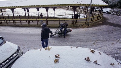 A biker falls on a slippery road after fresh snowfall in Shimla, Himachal Pradesh, (PTI) A biker falls on a slippery road after fresh snowfall in Shimla, Himachal Pradesh, (PTI)