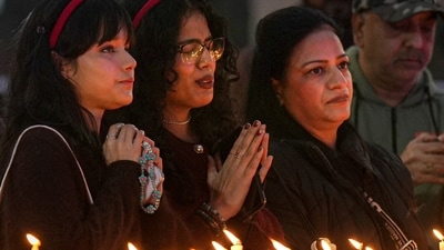 At Delhi's Sacred Hearts Cathedral, people were seen offering prayers and lighting candles (PTI) At Delhi's Sacred Hearts Cathedral, people were seen offering prayers and lighting candles (PTI)