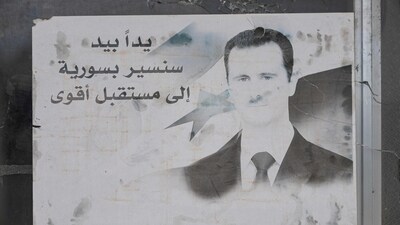 A portrait of toppled Syrian president Bashar al-Assad adorns the 4th Division barracks of the toppled Syrian army, in the town of Dummar near Damascus, (AFP) A portrait of toppled Syrian president Bashar al-Assad adorns the 4th Division barracks of the toppled Syrian army, in the town of Dummar near Damascus, (AFP)