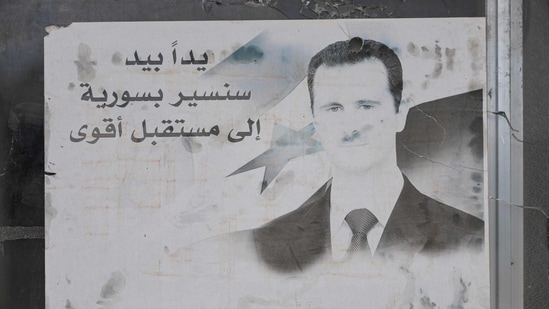 A portrait of toppled Syrian president Bashar al-Assad adorns the 4th Division barracks of the toppled Syrian army, in the town of Dummar near Damascus, (AFP)