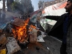 A banner with an image depicting the ousted Syrian President Bashar Assad is placed on the fire as a Syrian member of the rebel forces destroys drugs and alcoholic beverages, found at a complex building in Damascus, Syria, Wednesday, A banner with an image depicting the ousted Syrian President Bashar Assad is placed on the fire as a Syrian member of the rebel forces destroys drugs and alcoholic beverages, found at a complex building in Damascus, Syria, Wednesday,