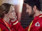 This image released by Hallmark Media shows Hunter King, left, and Tyler Hynes in a scene from "Holiday Touchdown: A Chiefs Love Story. (Joshua Haines/Hallmark Media via AP)
