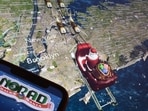 (FILES) This illustration photo shows the NORAD logo on a cell phone screen while the tracker follows Santa flying over New York City on a computer monitor in Los Angeles on December 24, 2023.