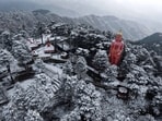 An aerial view of snow-covered statue of lord Hanuman at Jakhoo hill after fresh snowfall in Shimla on Tuesday. 