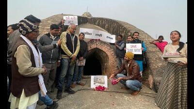 Enthusiasts at ‘Shahi Hammam’ after the walk organised on Wednesday to save the ancient structure. (HT Photo)