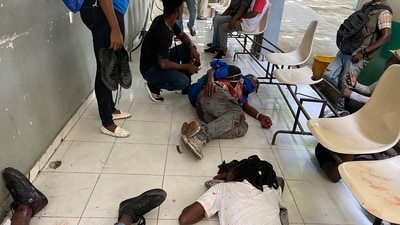 Journalists lie wounded after being shot by armed gangs at the general hospital in Port-au-Prince, Haiti, on Tuesday. (AP) Journalists lie wounded after being shot by armed gangs at the general hospital in Port-au-Prince, Haiti, on Tuesday. (AP)