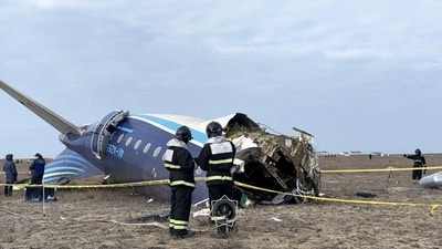Emergency specialists work at the crash site of an Azerbaijan Airlines passenger plane near the city of Aktau. (REUTERS)