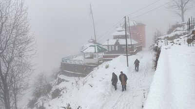 Mandi: People on their way during snowfall, in Mandi, Himachal Pradesh, Tuesday. (PTI) Mandi: People on their way during snowfall, in Mandi, Himachal Pradesh, Tuesday. (PTI)