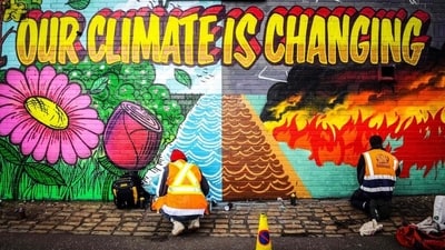 Street artists paint a mural on climate change. (AFP File Photo) Street artists paint a mural on climate change. (AFP File Photo)