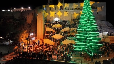 Syrian citizens gather outside Saydnaya Convent during the lighting of the Christmas tree, in Saydnaya town on the outskirts of Damascus, Syria. Exchanging gifts is a key tradition, symbolizing the gifts presented to Jesus by the Wise Men and expressing goodwill. (AP)