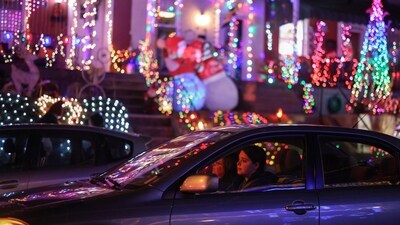 A woman drives past Christmas lights decorations in the Hampden area of Baltimore, Maryland, US, A beloved figure in Christmas tradition, Santa Claus, inspired by Saint Nicholas, delivers gifts to children on Christmas Eve.&nbsp; (REUTERS)