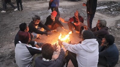 People sit around a bonfire to warm themselves on a winter evening, in New Delhi, Tuesday, Dec. 24, 2024. (PTI) People sit around a bonfire to warm themselves on a winter evening, in New Delhi, Tuesday, Dec. 24, 2024. (PTI)
