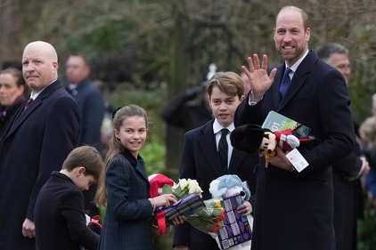 Prince William, right, with his children Prince George, Princess Charlotte and Prince Louis hold a collection of gifts at St Mary Magdalene Church in Sandringham in Norfolk, England, Wednesday, Dec. 25, 2024. (AP Photo/Jon Super) (AP)