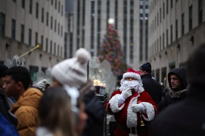 A man dressed as Santa stands in front of the Rockefeller Center Christmas Tree in Manhattan in New York City, US, December 24, 2024. (REUTERS)