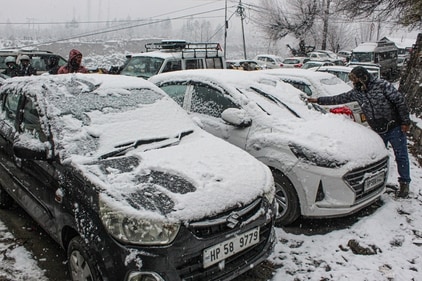 Manali: A man removes snow from vehicles after fresh snowfall, in Manali, Himachal Pradesh, Tuesday, Dec. 24, 2024. (PTI) Manali: A man removes snow from vehicles after fresh snowfall, in Manali, Himachal Pradesh, Tuesday, Dec. 24, 2024. (PTI)