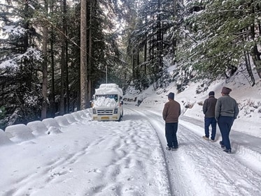 Pedestrians on a snow-covered road after fresh snowfall at Harsil Valley, in Uttarkashi district, Uttarakhand, Wednesday, Dec. 25, 2024. (PTI) Pedestrians on a snow-covered road after fresh snowfall at Harsil Valley, in Uttarkashi district, Uttarakhand, Wednesday, Dec. 25, 2024. (PTI)