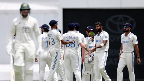 India's Jasprit Bumrah (R) celebrates with teammates after bowling Australia's Usman Khawaja (L) on day five of the third cricket Test match. (AFP)