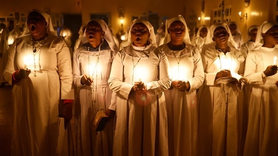 Worshippers of the Legio Maria African Church Mission attend the Christmas Eve vigil mass at St. Helena Mathare Parish in the informal settlement of Mathare in Nairobi, Kenya. Singing Christmas carols—joyful songs celebrating the holiday—is a popular custom in many cultures during the season.(AFP)