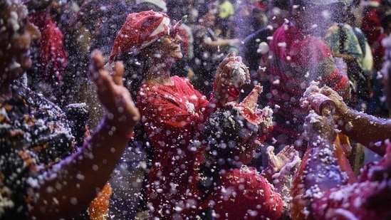 People play with artificial snow made of foam on Christmas eve in Kuala Lumpur on December 24, 2024. While Christmas is primarily a Christian holiday, it is celebrated worldwide, often with secular traditions alongside religious observances.(AFP)