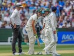 India's Virat Kohli, right, talks to Australia's Sam Konstas, second left, as Australia's Usman Khawaja, looks on during play on the first day of the fourth cricket test