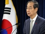 The largest opposition party in South Korea said that it would present a measure to remove acting President Han Duck-soo from office. 