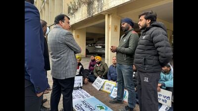 A PPCB official interacts with protesters in Ludhiana on Thursday. (HT photo)