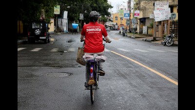 A delivery worker of Zomato, an Indian food-delivery startup, rides her bicycle along a road in Kolkata. (REUTERS) A delivery worker of Zomato, an Indian food-delivery startup, rides her bicycle along a road in Kolkata. (REUTERS)