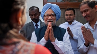 FILE - Former Indian prime minister Manmohan Singh, center, gestures after a short meeting with the newly elected office bearers of "National Students' Union Of India" (NSUI), who called on him at his residence in New Delhi in 2015 (AP)