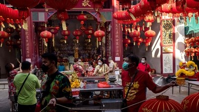 9. Bangkok, Thailand - People hang Chinese lanterns while others light incense sticks at a shrine to mark the start of the New Year in Bangkok. Bangkok’s lively street parties and rooftop bars make it an exciting place to ring in the New Year. The city's vibrant atmosphere, street food, and riverfront fireworks add to the appeal. (Photo by Jack TAYLOR / AFP) 9. Bangkok, Thailand - People hang Chinese lanterns while others light incense sticks at a shrine to mark the start of the New Year in Bangkok. Bangkok’s lively street parties and rooftop bars make it an exciting place to ring in the New Year. The city's vibrant atmosphere, street food, and riverfront fireworks add to the appeal. (Photo by Jack TAYLOR / AFP)