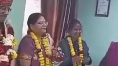 Both the husband and wife (second and second L) were seen wearing garlands and smiling during his farewell at office. (X/@B_L__VERMA)