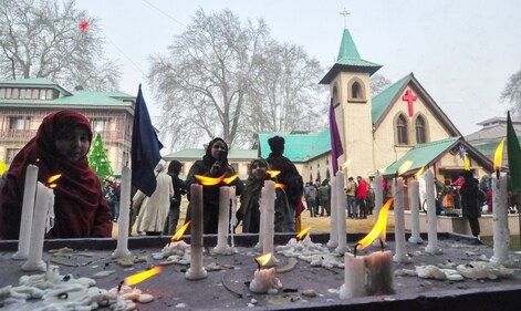 Devotees light candles during the Christmas celebration at the Holy Family Catholic Church in Srinagar on Wednesday. (ANI) Devotees light candles during the Christmas celebration at the Holy Family Catholic Church in Srinagar on Wednesday. (ANI)