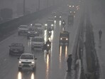 Vehicles ply on Delhi-Gurugram Expressway during rain on a cold winter day, in Gurugram on Friday. Vehicles ply on Delhi-Gurugram Expressway during rain on a cold winter day, in Gurugram on Friday.