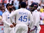 India's Virat Kohli (L) speaks with teammates Rohit Sharma (C) and Rishabh Pant (R)
