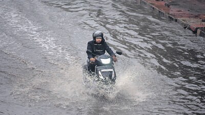 A commuter wades through a water logged stretch near East Vinod Nagar on Friday. (RAJ K RAJ /HT PHOTO) A commuter wades through a water logged stretch near East Vinod Nagar on Friday. (RAJ K RAJ /HT PHOTO)