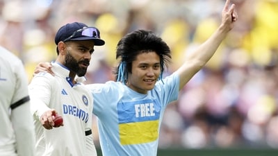 A pitch invader is seen with India's Virat Kohli on the second day of the fourth cricket Test (AFP) A pitch invader is seen with India's Virat Kohli on the second day of the fourth cricket Test (AFP)