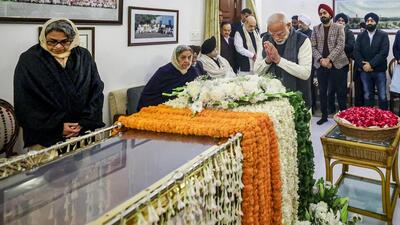 New Delhi: Prime Minister Narendra Modi pays his last respects to former prime minister Manmohan Singh at his residence in New Delhi on Friday. (PTI/narendramodi.in) New Delhi: Prime Minister Narendra Modi pays his last respects to former prime minister Manmohan Singh at his residence in New Delhi on Friday. (PTI/narendramodi.in)