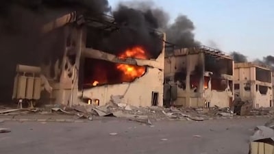 Yemen's Huthis' official Al-Masirah TV station on December 26, 2024, shows burning buildings following Israeli strikes on the Ras Kutaib power station in Hodeida. (AFP) Yemen's Huthis' official Al-Masirah TV station on December 26, 2024, shows burning buildings following Israeli strikes on the Ras Kutaib power station in Hodeida. (AFP)