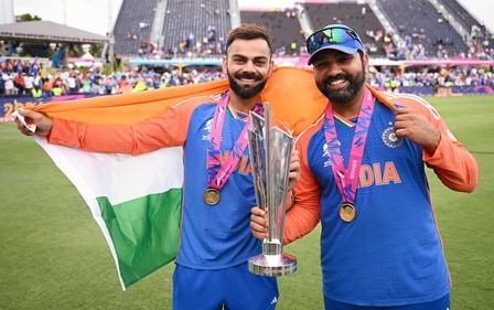 India's captain Rohit Sharma and Virat Kohli pose for a picture with the trophy after Team India wins the ICC Mens T20 World Cup 2024. (ICC - X ) India's captain Rohit Sharma and Virat Kohli pose for a picture with the trophy after Team India wins the ICC Mens T20 World Cup 2024. (ICC - X )